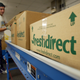 A worker shepherds finished grocery boxes ready for delivery at FreshDirect warehouse Dec. 5, 2002, in New York City.
Mario Tama/Getty Images